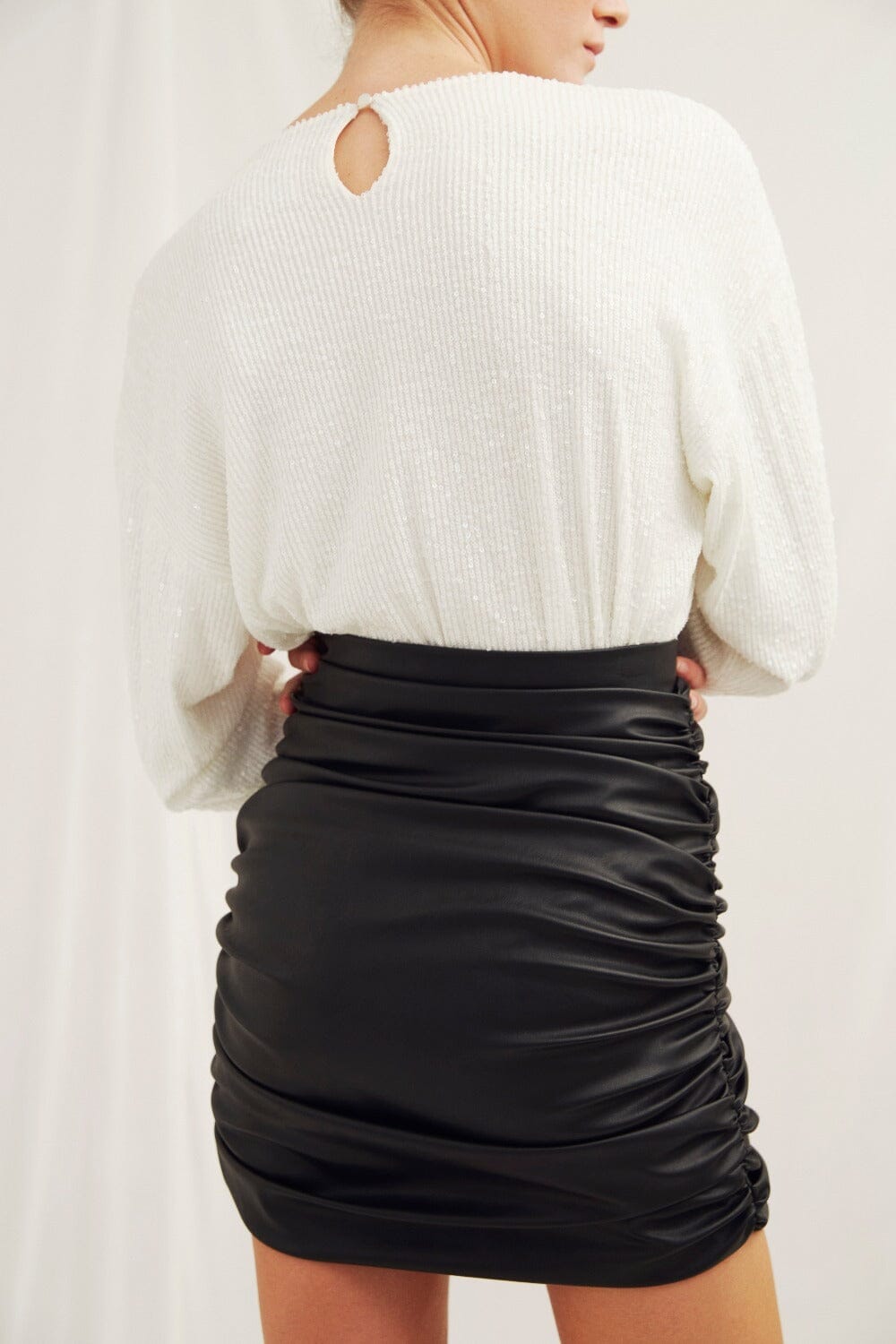 Chels Ruched Vegan Leather Mini Skirt in Black Nazli Ceren