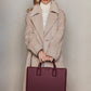 Model holding Qosmic Metis Nebula - burgundy briefcase