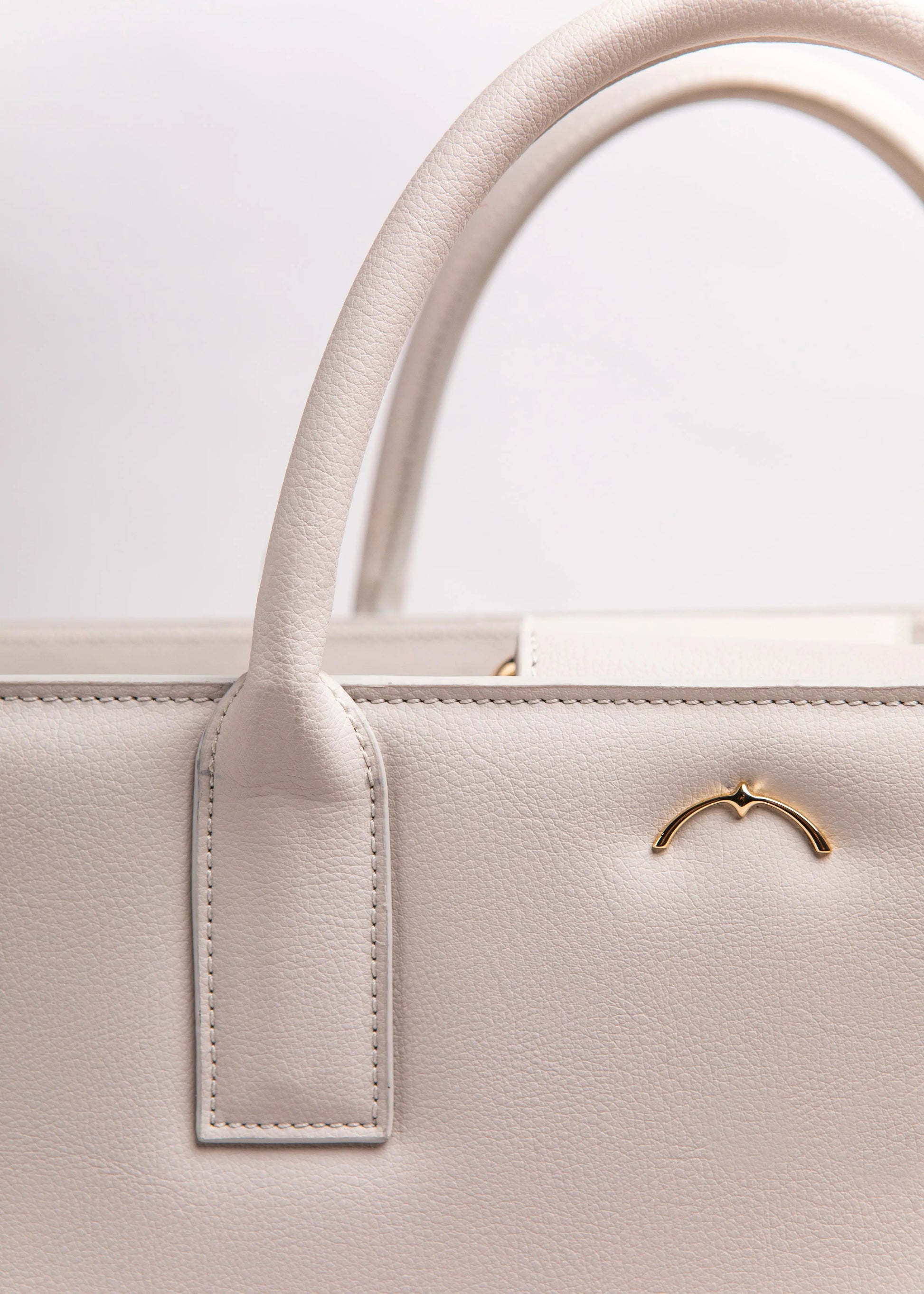 Qosmic Metis Moonstone - cream briefcase - logo detail